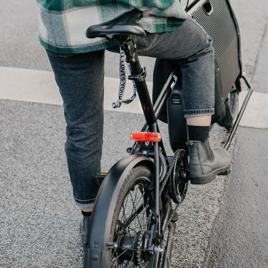 Frau gibt auf die Pedale von Muli Motor in schwarz nightride gas.